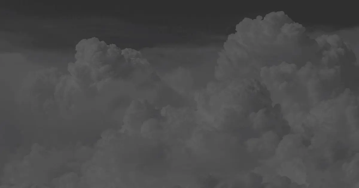 Dark, ominous storm clouds fill the frame, creating a moody and dramatic atmosphere. The scene conveys a sense of impending weather change